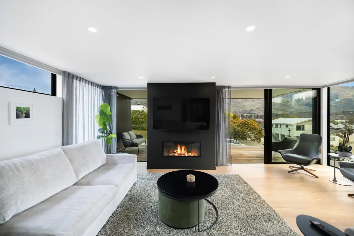 Modern Lounge with Fireplace and Glimpses of Lake Wānaka 
